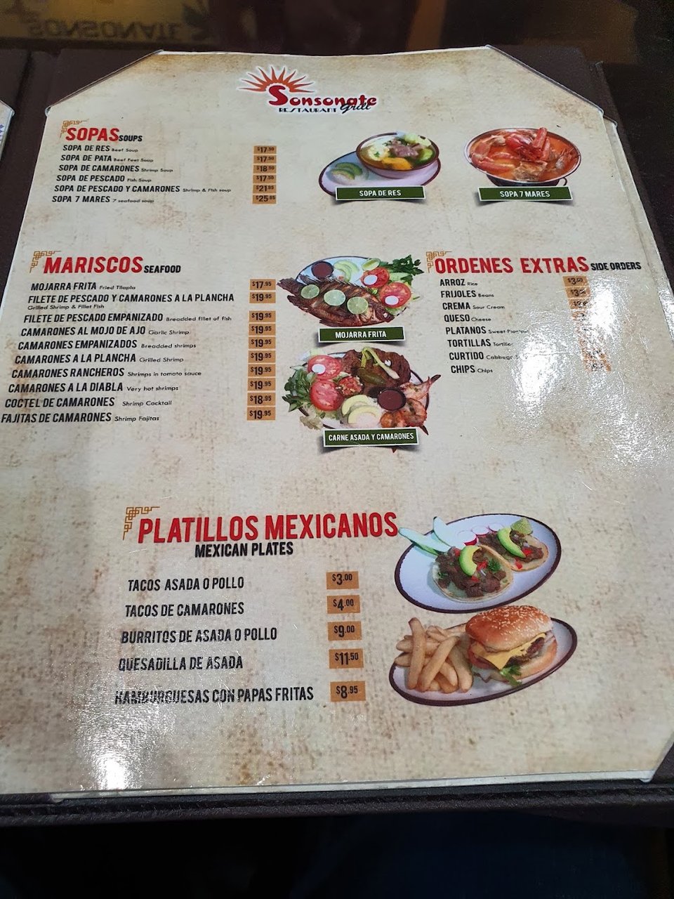 Printed menu showing pupusas and other plates.